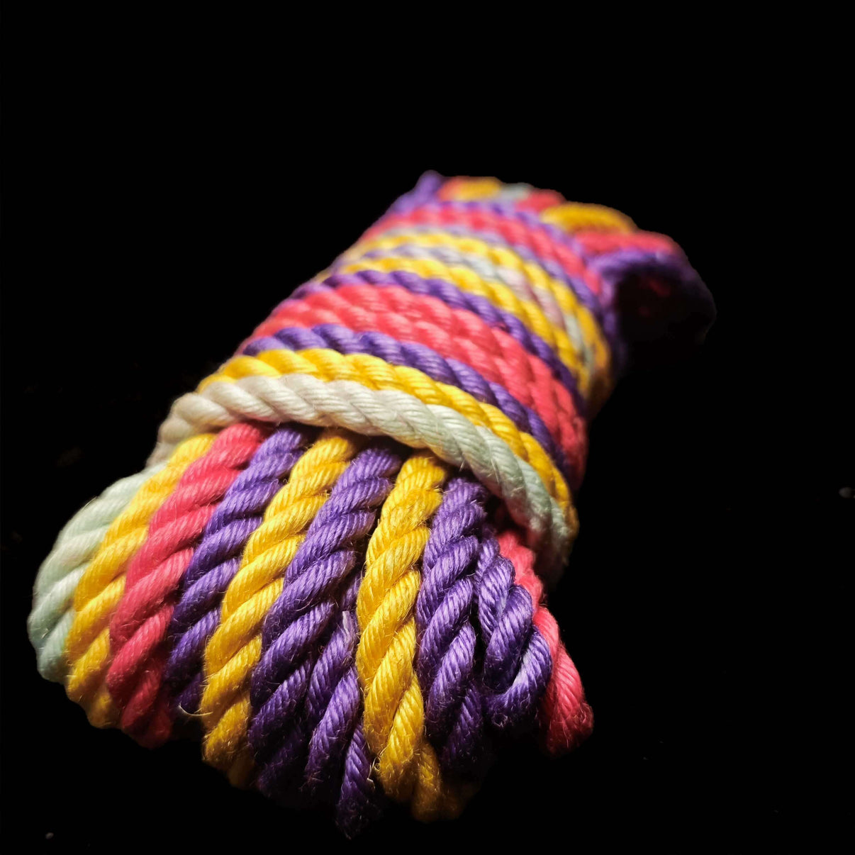 Rainbow jute rope in vibrant colors including pink, yellow, purple, and white, showcasing eco-friendly material.